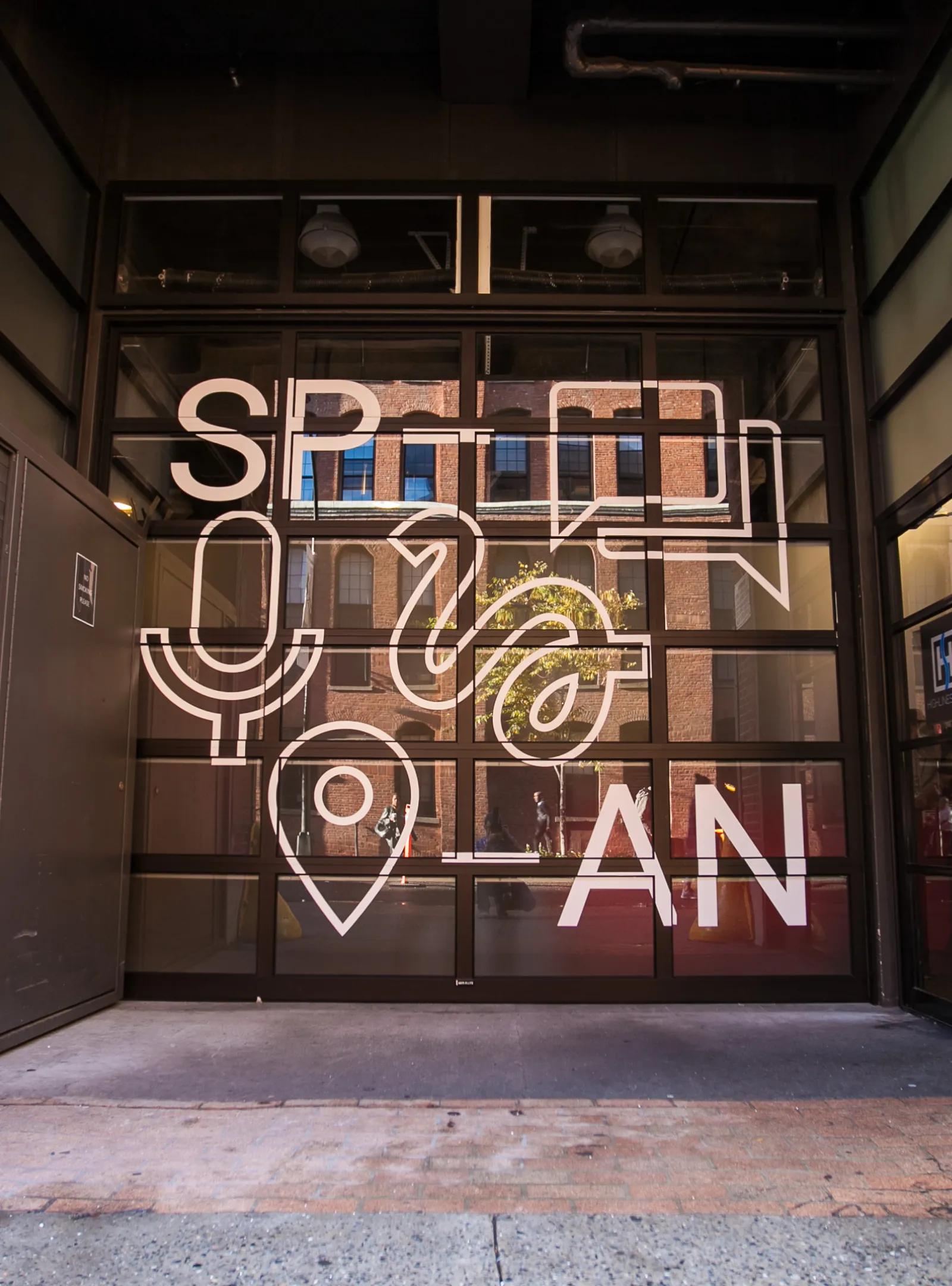 Industrial steel window with a decal reading SPAN.